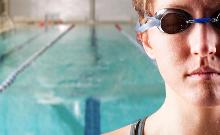 donna con gli occhialini a bordo piscina