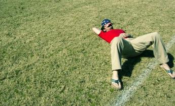 Ragazzo sdraiato su campo da calcio